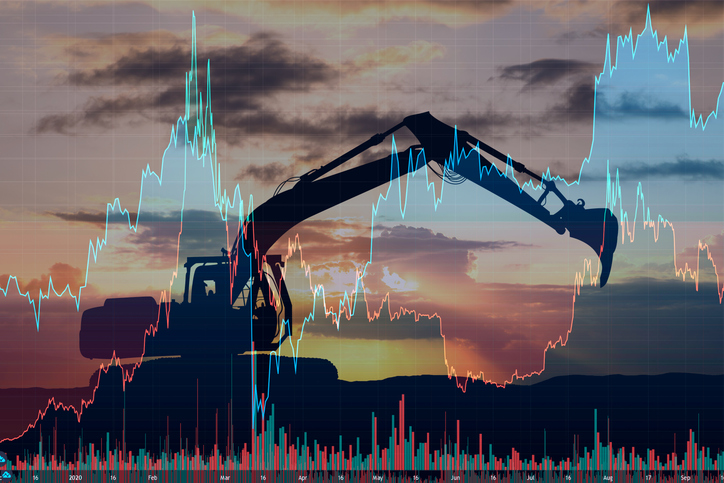 Technical Reporting Overlay of technical reporting charts over excavator at mine site at sunrise